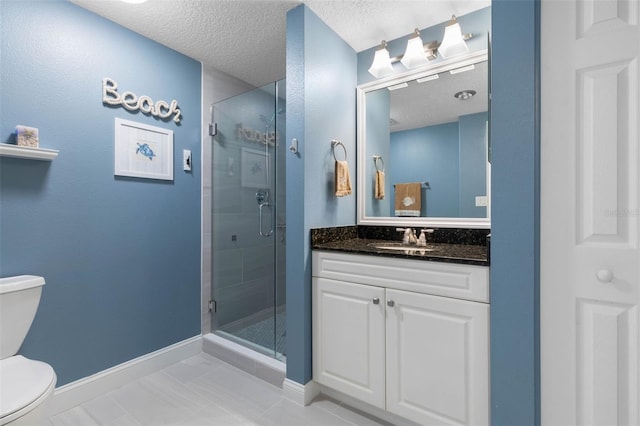 bathroom with a textured ceiling, a shower stall, toilet, and baseboards