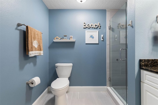 bathroom with baseboards, toilet, a textured ceiling, vanity, and a shower stall