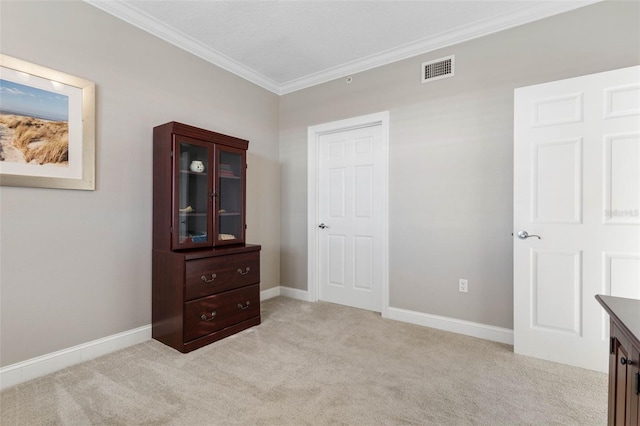 bedroom with visible vents, baseboards, crown molding, and light colored carpet