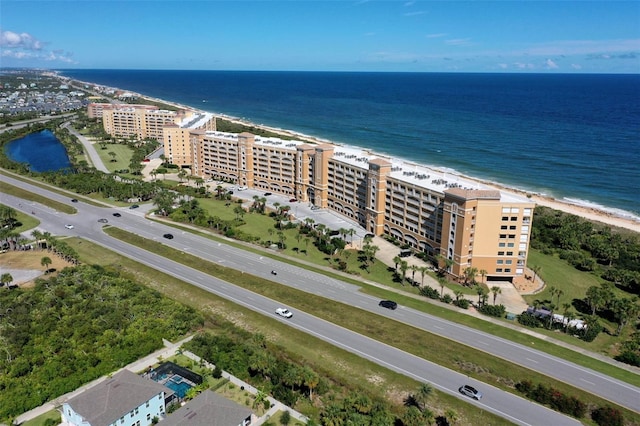 birds eye view of property featuring a water view and a view of the beach