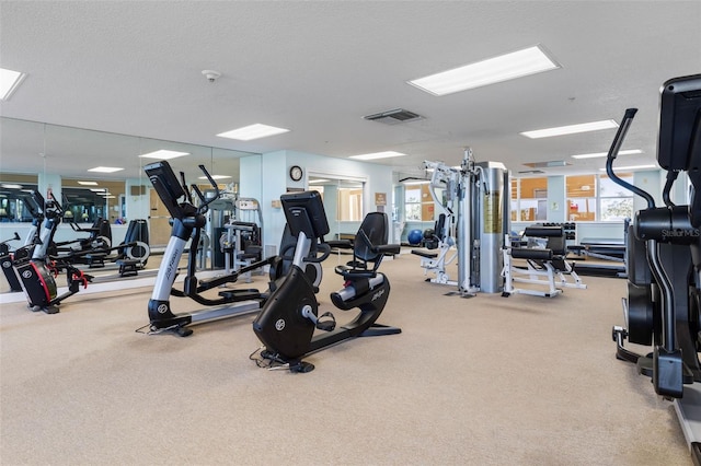 gym featuring a textured ceiling and visible vents