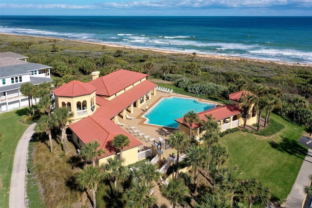 drone / aerial view with a beach view and a water view