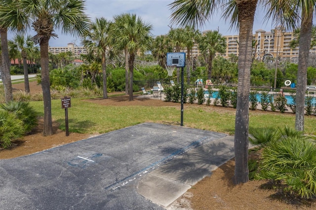 view of basketball court with a yard