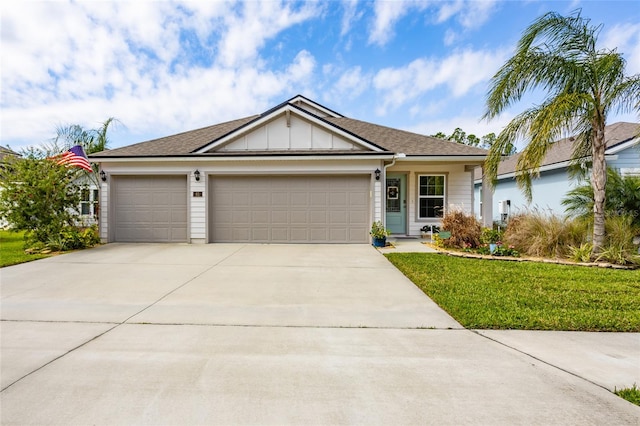 single story home featuring an attached garage, a front yard, board and batten siding, and concrete driveway