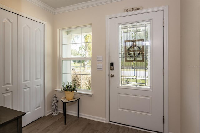 doorway to outside featuring a healthy amount of sunlight, ornamental molding, and wood finished floors