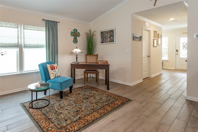 living area featuring a healthy amount of sunlight, crown molding, and wood finished floors