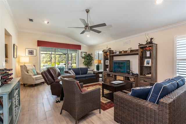 living area with light wood-style floors, visible vents, vaulted ceiling, and ornamental molding