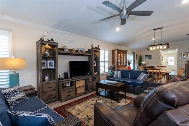 living area featuring ornamental molding, vaulted ceiling, ceiling fan, and wood finished floors