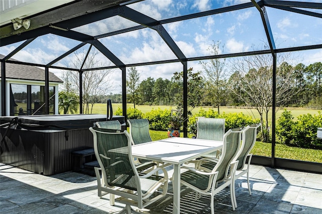 view of patio / terrace with outdoor dining space, a lanai, and a hot tub