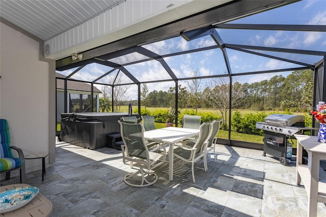 view of patio featuring glass enclosure, outdoor dining area, a grill, and a hot tub