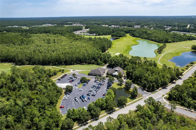 aerial view with a water view, a view of trees, and golf course view