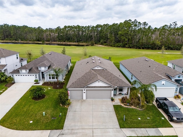 drone / aerial view with a wooded view