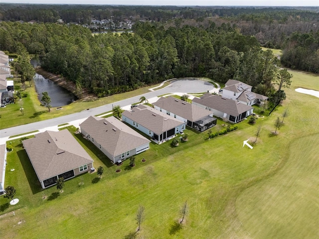 drone / aerial view featuring a residential view, a water view, and a wooded view