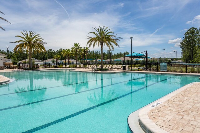 pool featuring a patio area and fence