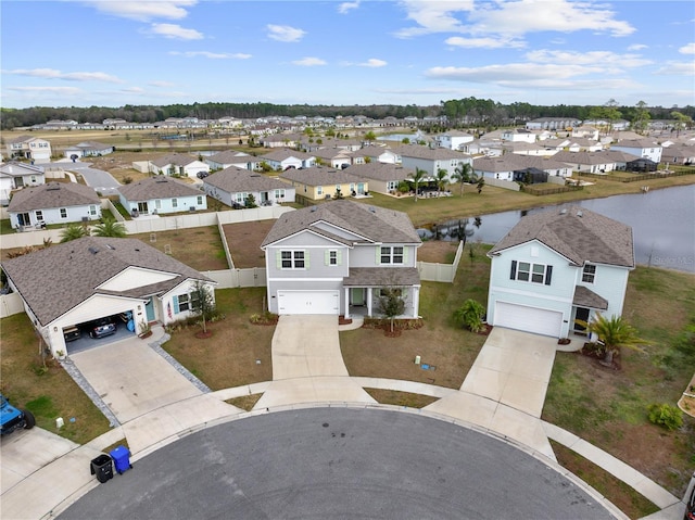 birds eye view of property featuring a water view and a residential view