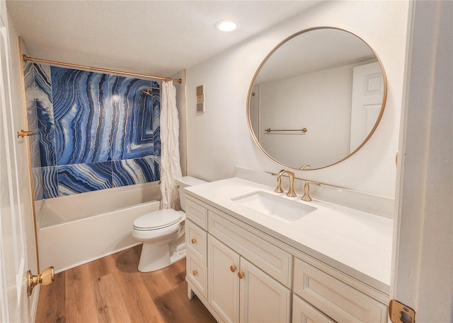 bathroom featuring visible vents, toilet, wood finished floors, shower / bath combination with curtain, and vanity