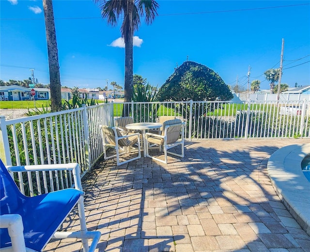 view of patio featuring outdoor dining space and fence