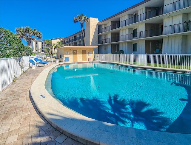 community pool featuring a patio area and fence