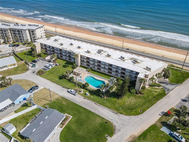 drone / aerial view featuring a water view and a view of the beach