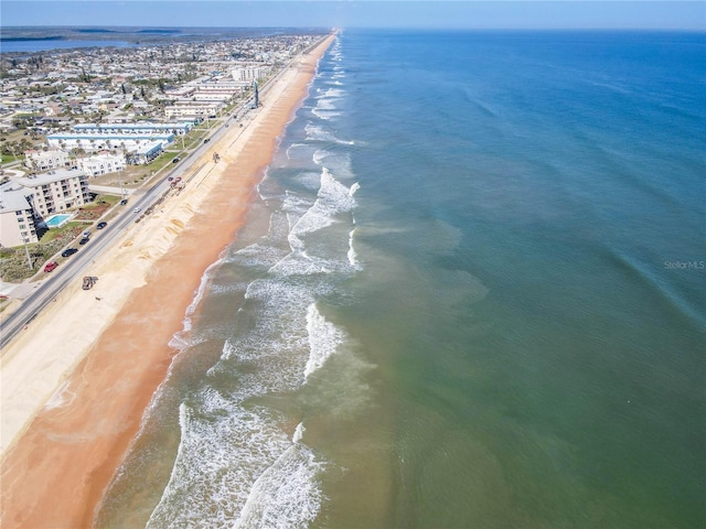 aerial view with a water view and a beach view