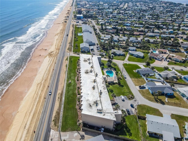 aerial view with a water view and a beach view