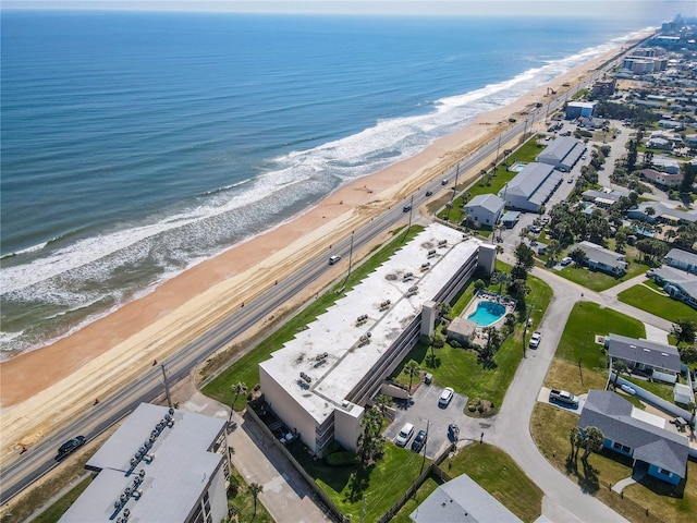 drone / aerial view with a water view and a beach view