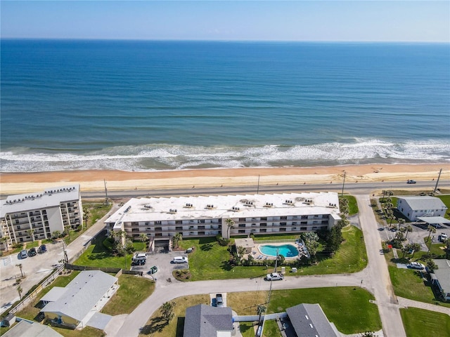 birds eye view of property with a water view and a view of the beach