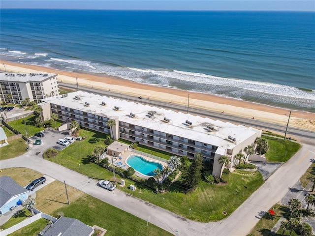 bird's eye view featuring a water view and a beach view