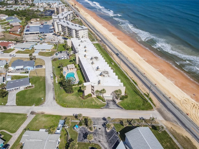 aerial view with a water view and a beach view