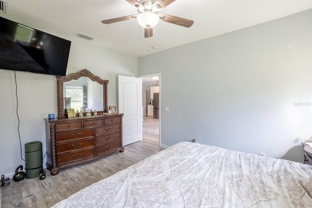 bedroom with visible vents, ceiling fan, and light wood finished floors