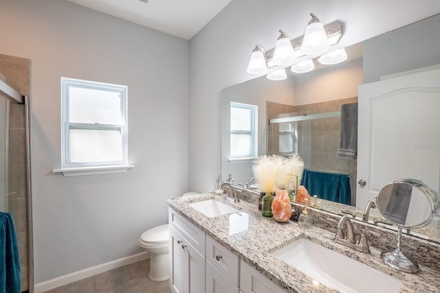 bathroom with tile patterned floors, a sink, toilet, and a shower stall