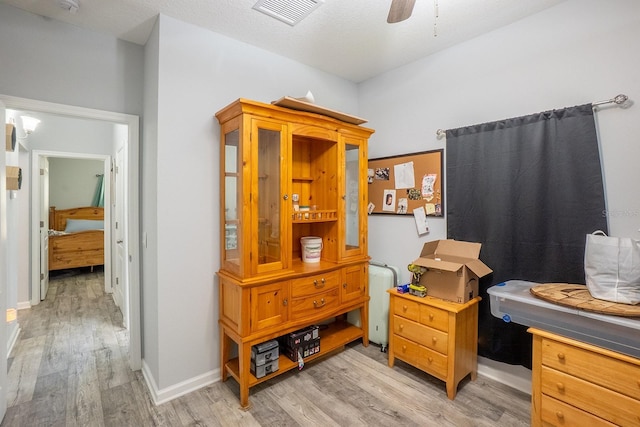 interior space with baseboards, visible vents, and light wood finished floors