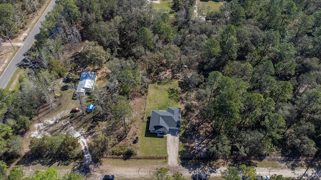 drone / aerial view featuring a view of trees