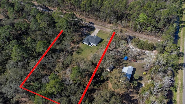 birds eye view of property with a view of trees