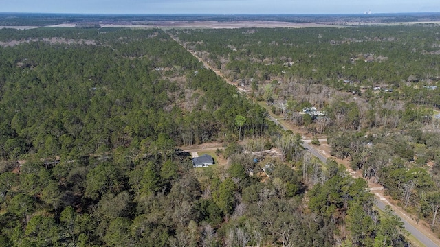 drone / aerial view with a wooded view