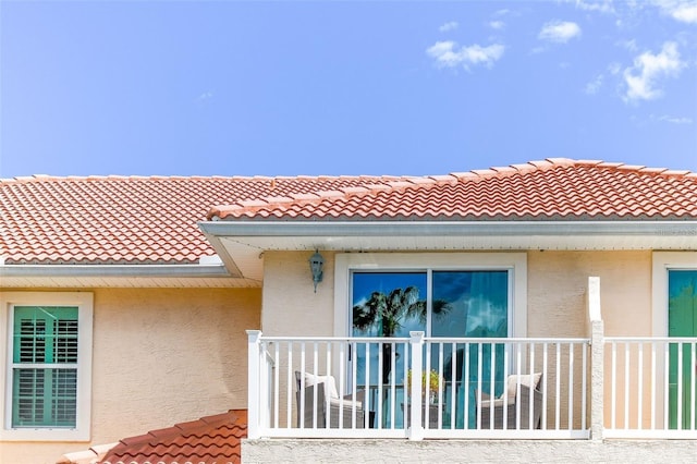 view of home's exterior featuring a tiled roof and stucco siding