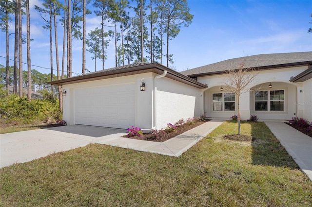 view of front of home with driveway, a front yard, an attached garage, and stucco siding