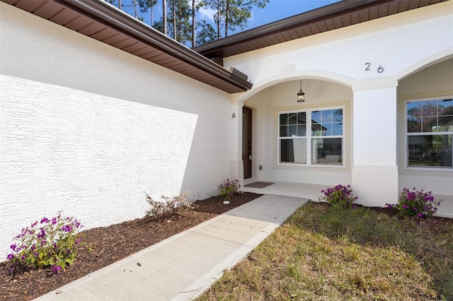 view of exterior entry with stucco siding