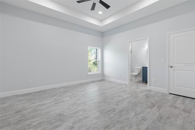 unfurnished bedroom with light wood finished floors, baseboards, connected bathroom, and recessed lighting