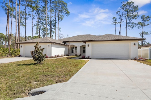 view of front of property featuring driveway, stucco siding, an attached garage, and a front yard