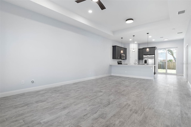 unfurnished living room with light wood-style floors, recessed lighting, visible vents, and baseboards