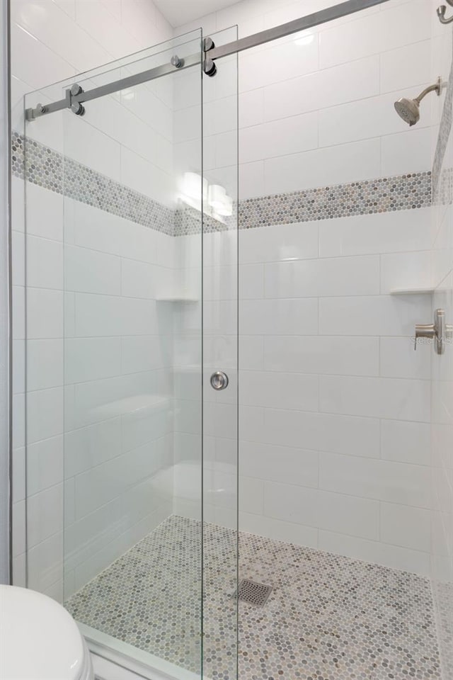 full bath with a shower stall and toilet