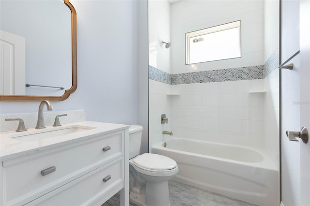 bathroom with vanity, toilet, and bathing tub / shower combination