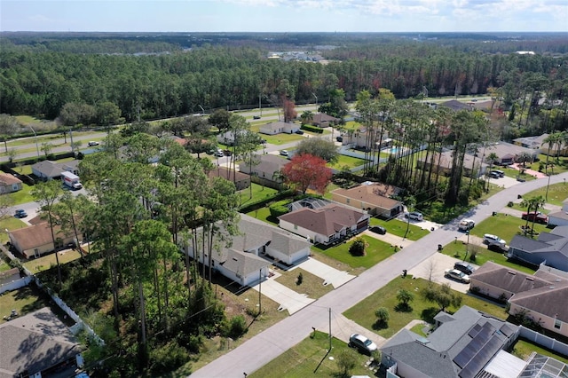 bird's eye view featuring a forest view and a residential view