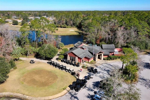 drone / aerial view featuring a water view and a wooded view