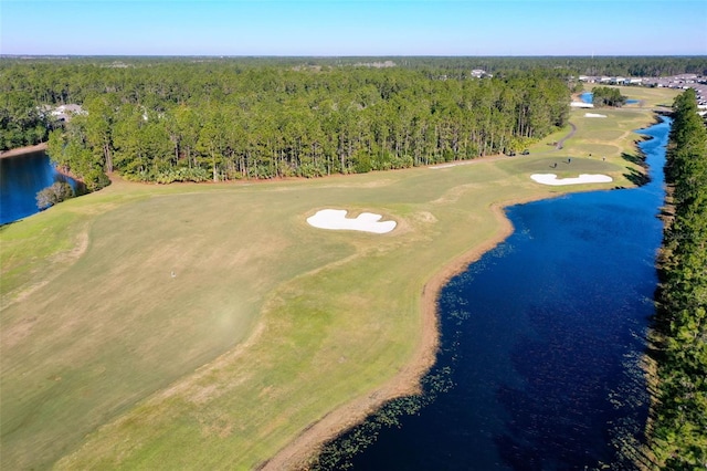 aerial view featuring a water view, view of golf course, and a wooded view