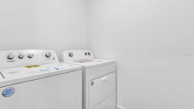 washroom featuring laundry area and washer and dryer