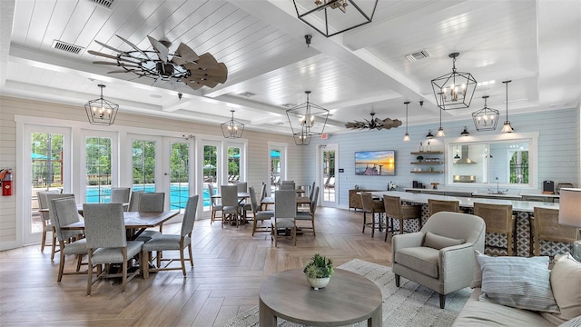 dining room with visible vents, plenty of natural light, and beamed ceiling