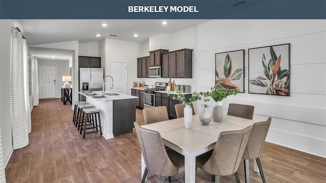 dining area with lofted ceiling, wood finished floors, and recessed lighting