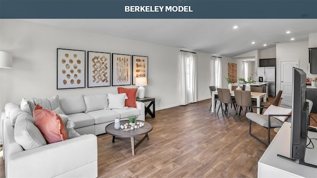 living area featuring lofted ceiling, baseboards, wood finished floors, and recessed lighting